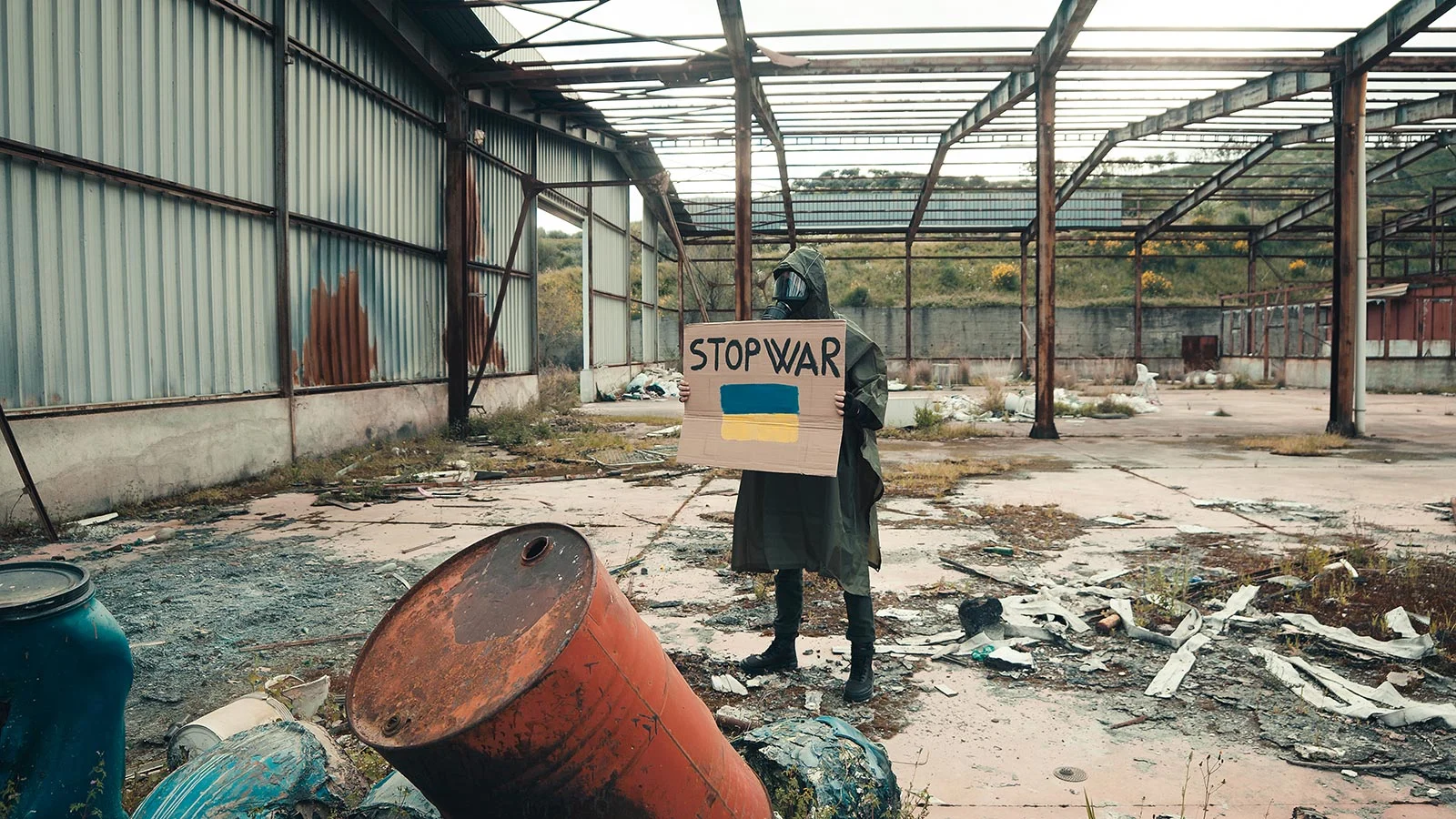 boy with gas mask holds cardboard