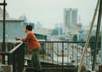 Man on city balcony