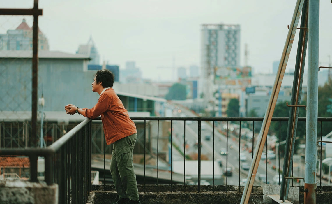 Man on city balcony